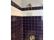 Tiled shower with dark blue tile accented by white, decorative border tile at 1255 North Nw Ave, Atlanta, GA 30318