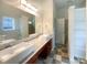 Bathroom featuring double vanity sinks, large mirror, updated lighting, and storage at 4893 Hairston Pl, Stone Mountain, GA 30088