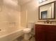 Bathroom featuring a tub, toilet, and vanity with a sink and mirror at 4893 Hairston Pl, Stone Mountain, GA 30088