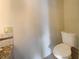 Bathroom featuring a toilet and partial view of the vanity at 4893 Hairston Pl, Stone Mountain, GA 30088