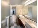 Modern bathroom featuring dual sinks, granite countertops, and stylish tile at 4893 Hairston Pl, Stone Mountain, GA 30088