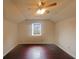 Bright bedroom features hardwood floors, vaulted ceiling, ceiling fan, and a window with natural light at 4893 Hairston Pl, Stone Mountain, GA 30088