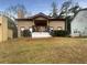 Inviting home with a charming front porch, stucco exterior, and well-maintained lawn at 4893 Hairston Pl, Stone Mountain, GA 30088