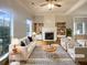 Bright living room featuring a fireplace, stylish furniture, and hardwood floors at 4893 Hairston Pl, Stone Mountain, GA 30088