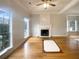 Spacious living room with fireplace, hardwood floors, and ample natural light at 4893 Hairston Pl, Stone Mountain, GA 30088