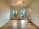 Living room featuring two windows letting in natural light and hardwood flooring at 4893 Hairston Pl, Stone Mountain, GA 30088