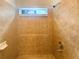 Shower featuring ceramic tiling, shower head, and a small window for natural light at 4893 Hairston Pl, Stone Mountain, GA 30088
