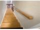 Staircase with natural wood stairs and banister leads to the next level of this lovely home at 4893 Hairston Pl, Stone Mountain, GA 30088