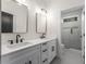 Modern bathroom features double sink vanity with black hardware and shower with decorative tile at 2261 Venetian Dr, Atlanta, GA 30311