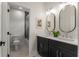 Modern bathroom featuring a double vanity with black cabinets and a tiled shower/tub combo at 2261 Venetian Dr, Atlanta, GA 30311