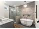 Spa-like bathroom with a soaking tub, walk-in shower, and a chandelier for a touch of elegance at 2261 Venetian Dr, Atlanta, GA 30311