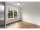 Bright bedroom featuring hardwood floors and a large window with natural light at 2261 Venetian Dr, Atlanta, GA 30311