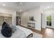 This bedroom features neutral decor, hardwood floors, an ensuite bathroom, and access to the home's exterior at 2261 Venetian Dr, Atlanta, GA 30311