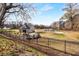 A well-maintained golf course area features a training building, fence, and golf carts for players at 2261 Venetian Dr, Atlanta, GA 30311