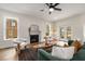 Beautiful living room featuring a fireplace, large windows, and hardwood floors at 2261 Venetian Dr, Atlanta, GA 30311