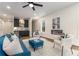 Open living room with a blue sofa, fireplace, bar area with cabinets, and hardwood floors at 2261 Venetian Dr, Atlanta, GA 30311