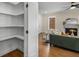 Walk-in pantry with shelving, next to the living room with fireplace and comfortable furniture at 2261 Venetian Dr, Atlanta, GA 30311