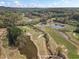 Beautiful aerial view of a neighborhood golf course and surrounding trees and ponds at 410 Hickory Fairway Ct, Woodstock, GA 30188