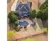 An aerial view of the property, showcasing the pool, patio area, large lawn, and surrounding greenery at 410 Hickory Fairway Ct, Woodstock, GA 30188