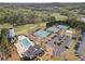 Aerial view of neighborhood amenities including tennis courts, pool, playground, parking lot and clubhouse at 410 Hickory Fairway Ct, Woodstock, GA 30188