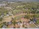 Neighborhood aerial shot with beautiful homes nestled among lush green trees at 410 Hickory Fairway Ct, Woodstock, GA 30188