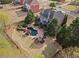 An aerial view showcases a backyard with a pool, a patio area with seating, and well-maintained landscaping at 410 Hickory Fairway Ct, Woodstock, GA 30188