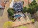 Aerial shot of a home featuring a backyard oasis with a pool, patio, and beautiful landscaping at 410 Hickory Fairway Ct, Woodstock, GA 30188