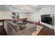 Finished basement with a large gray couch and a flat screen TV, perfect for entertaining or relaxing at 410 Hickory Fairway Ct, Woodstock, GA 30188