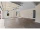 Spacious and clean garage with natural light, neutral paint, and an entrance door at 410 Hickory Fairway Ct, Woodstock, GA 30188
