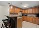 Charming kitchen with granite counters, tiled backsplash, a breakfast bar, and ample cabinet space at 410 Hickory Fairway Ct, Woodstock, GA 30188