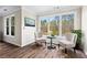 Cozy sitting area with lots of natural light from the surrounding windows and hardwood floors at 410 Hickory Fairway Ct, Woodstock, GA 30188