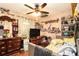 Eclectic bedroom with a ceiling fan, a bed, decorative shelves and a vintage wood dresser at 160 Wesley Chapel Rd, Villa Rica, GA 30180