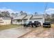 Exterior view of a cozy home featuring a long driveway and a spacious two-car garage at 160 Wesley Chapel Rd, Villa Rica, GA 30180