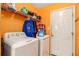 Practical laundry room equipped with a washing machine, dryer and shelving at 160 Wesley Chapel Rd, Villa Rica, GA 30180