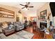 Inviting living room featuring hardwood floors, a fireplace, and an open view of the dining area at 160 Wesley Chapel Rd, Villa Rica, GA 30180