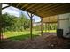 View from under deck to wooded backyard with lush lawn in a neighborhood at 201 Retreat Ln, Canton, GA 30114