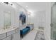 Bright bathroom featuring a double vanity, a walk-in shower, and a decorative blue accent bench at 201 Retreat Ln, Canton, GA 30114