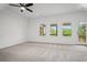 Spacious bedroom featuring three windows and an access door to a wooden deck at 201 Retreat Ln, Canton, GA 30114