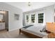 Bedroom featuring large windows, neutral carpeting, and ensuite bath at 201 Retreat Ln, Canton, GA 30114