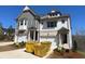 New two-story home with gray and white facade and two-car garage at 201 Retreat Ln, Canton, GA 30114