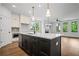 Modern kitchen features a center island, stainless steel appliances, and white cabinets at 201 Retreat Ln, Canton, GA 30114