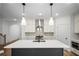 Modern kitchen features a center island, stainless steel appliances, and white cabinets at 201 Retreat Ln, Canton, GA 30114