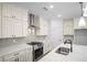Modern kitchen features a center island, stainless steel appliances, and white cabinets at 201 Retreat Ln, Canton, GA 30114