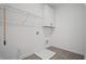 Neat laundry room with upper cabinet, wire shelving and tiled flooring at 201 Retreat Ln, Canton, GA 30114