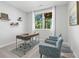 A bright home office with a modern desk, and two comfortable blue chairs with nature view at 201 Retreat Ln, Canton, GA 30114