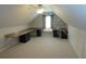 A large attic room with desk and storage cabinets creates a versatile workspace at 735 Sunset Ridge Ln, Lawrenceville, GA 30045