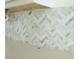 Herringbone patterned tile backsplash is installed above a counter with a sink at 735 Sunset Ridge Ln, Lawrenceville, GA 30045