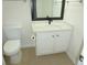 Bright bathroom featuring a vanity with stone countertop, modern fixtures, and toilet at 735 Sunset Ridge Ln, Lawrenceville, GA 30045