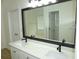 Bright bathroom featuring a double vanity with stone countertop and modern fixtures at 735 Sunset Ridge Ln, Lawrenceville, GA 30045