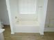 A bathtub with tile surround and a window with blinds at 735 Sunset Ridge Ln, Lawrenceville, GA 30045